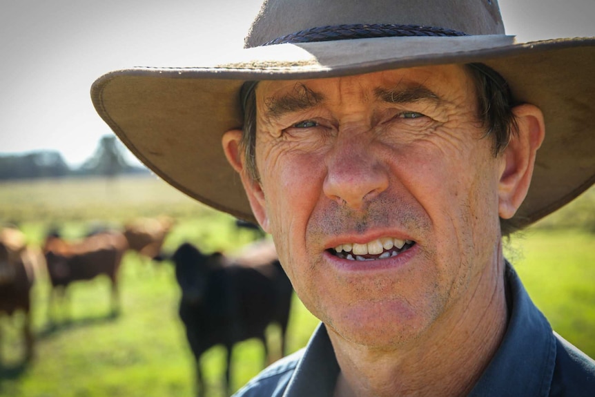 Tight photo of the face of Kingaroy farmer Damien O'Sullivan in a paddock