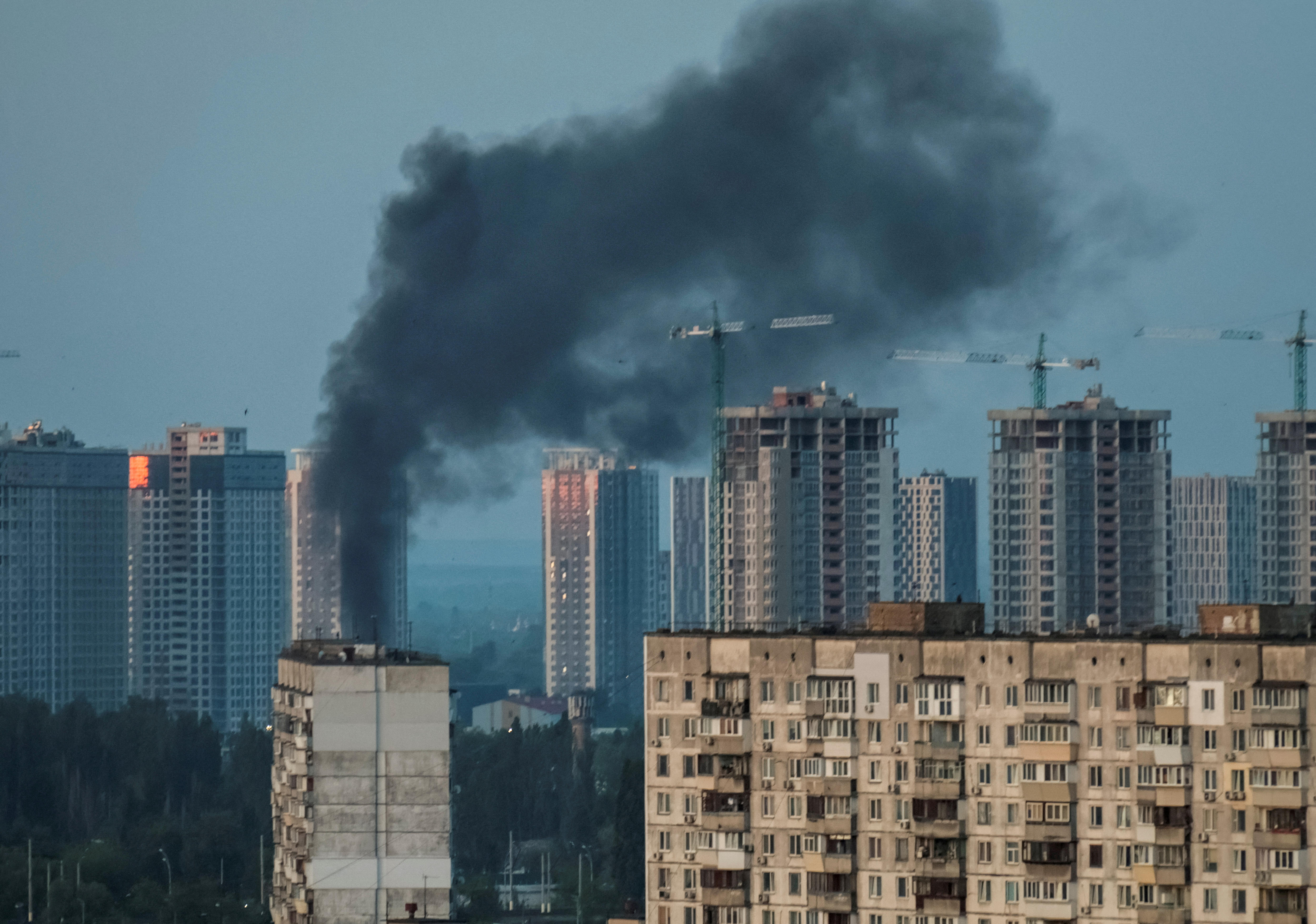 A view of the city skyline shows smoke rising from a building in Kyiv, Ukraine
