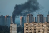 A view of the city skyline shows smoke rising from a building in Kyiv, Ukraine