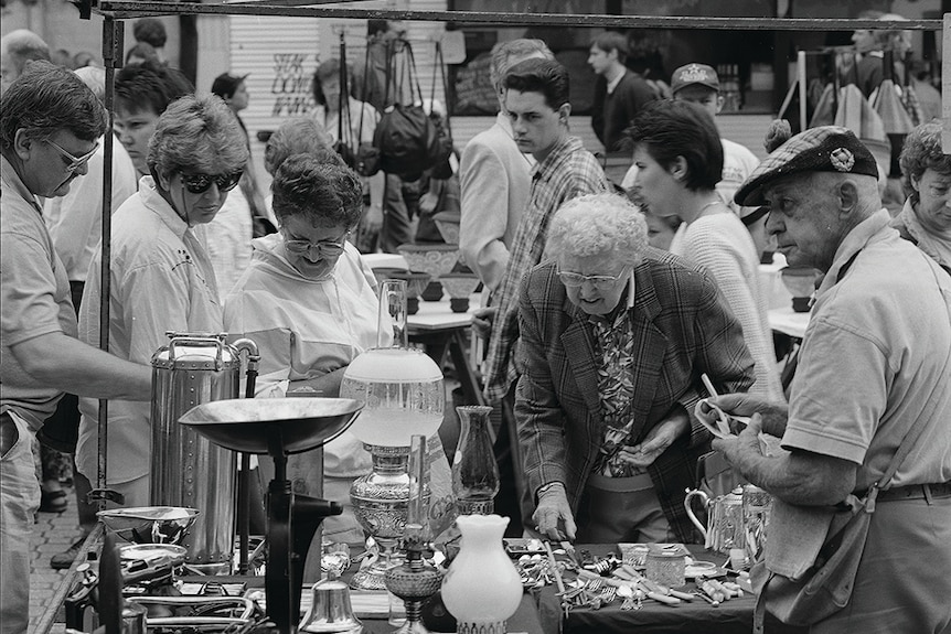 Prospective buyers appraise items for sale at Salamanca Market.