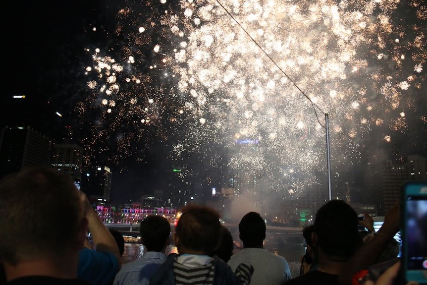 People watch New Years fireworks in Brisbane.