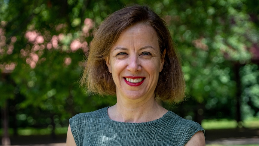 A woman wearing a green top