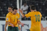 Harry Kewell and Lucas Neill celebrate Australia's World Cup qualification after drawing with Qatar.