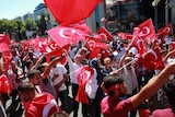 People wave national flags on the streets of Ankara.