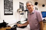 Associate professor Nigel Marks holds a Geiger counter. 