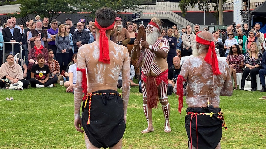 Aboriginal men perform a traditional smoking ceremony.