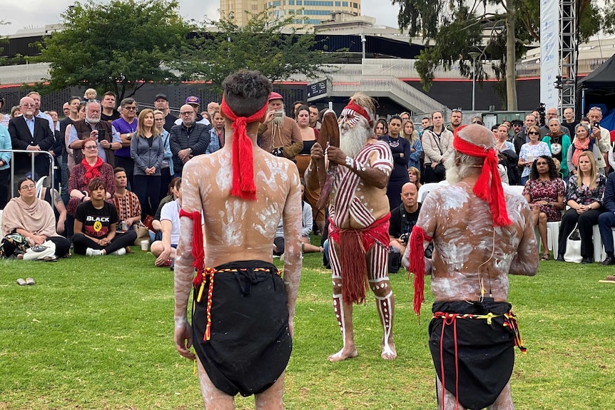 Aboriginal men perform a traditional smoking ceremony.