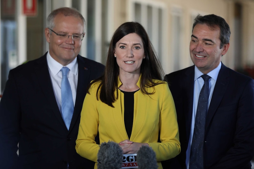 Nicolle Flint, Scott Morrison and Steven Marshall stand in front of microphones for a press conference