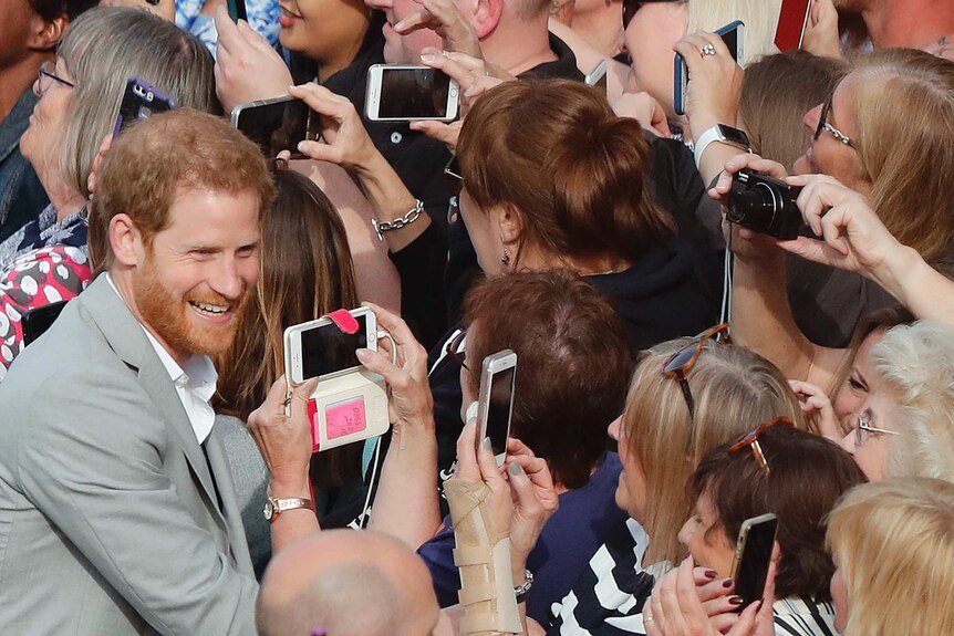 Prince Harry greets crowds in Windsor ahead of the wedding.