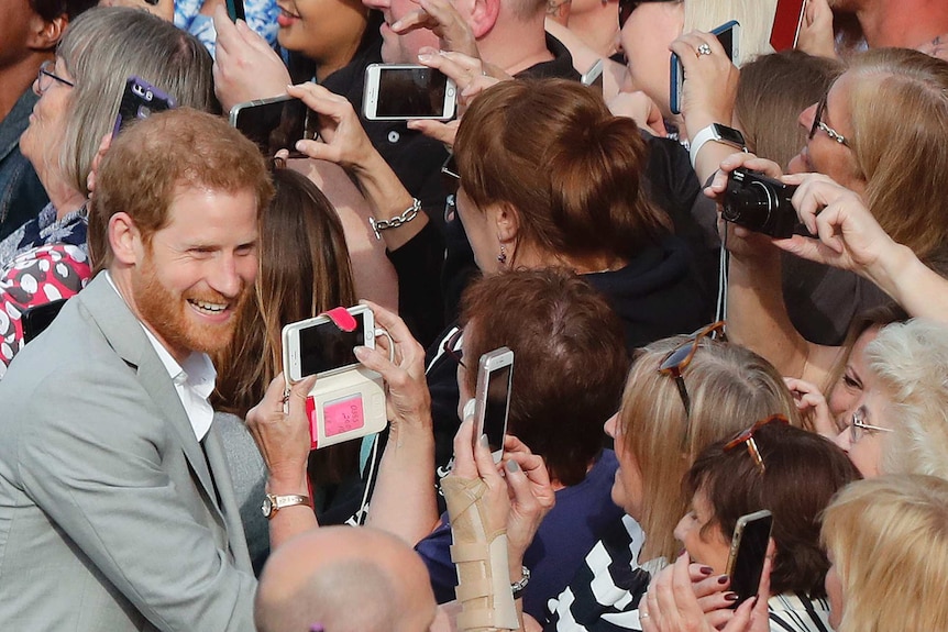 Prince Harry greets crowds in Windsor ahead of the wedding.