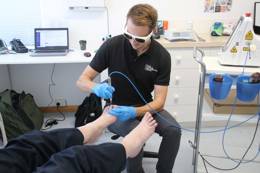 Launceston Podiatrist Manning Mitchell treating a patient, May 2019