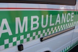 The side panel of a St John Ambulance vehicle close-up.