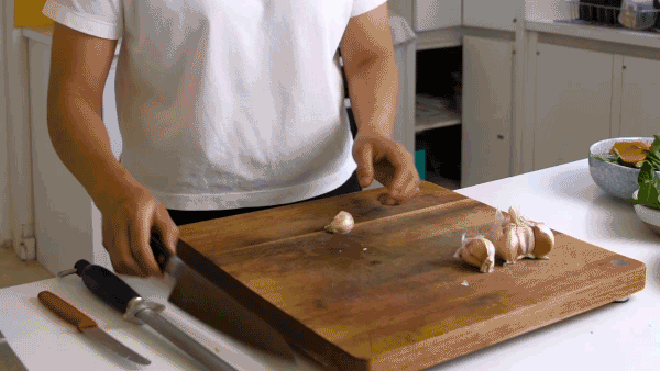 Thi Le demonstrates how to bash and finely mince garlic with a chef's knife.