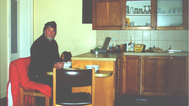 Mr Watts sitting in the kitchen of their accommodation on Maatsuyker Island.