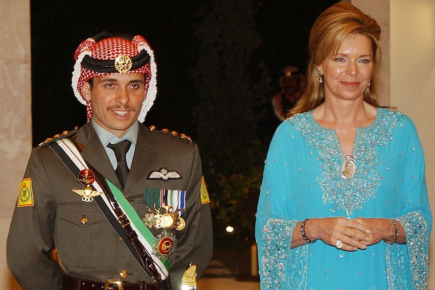 Jordan's Prince Hamza, dressed in military uniform, stands with his mother Queen Noor, who wears a light blue dress.