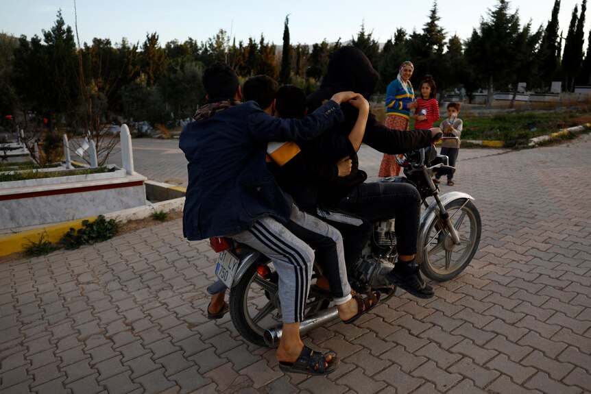 People ride a motorbike. 