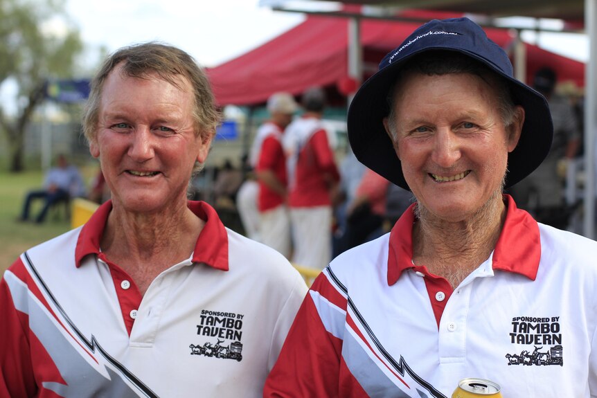 Two cricket players in their 60s smiling 