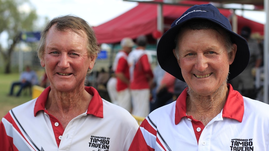 Two cricket players in their 60s smiling 