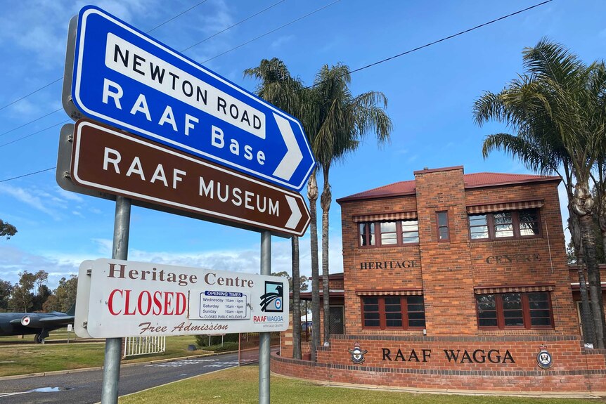 A sign saying RAAF base and RAAF Museum pointing towards a brick building.