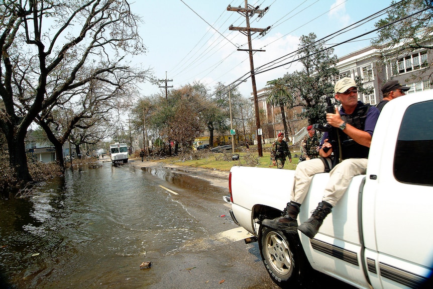 Private security forces ride in the back of a ute in New Orleans