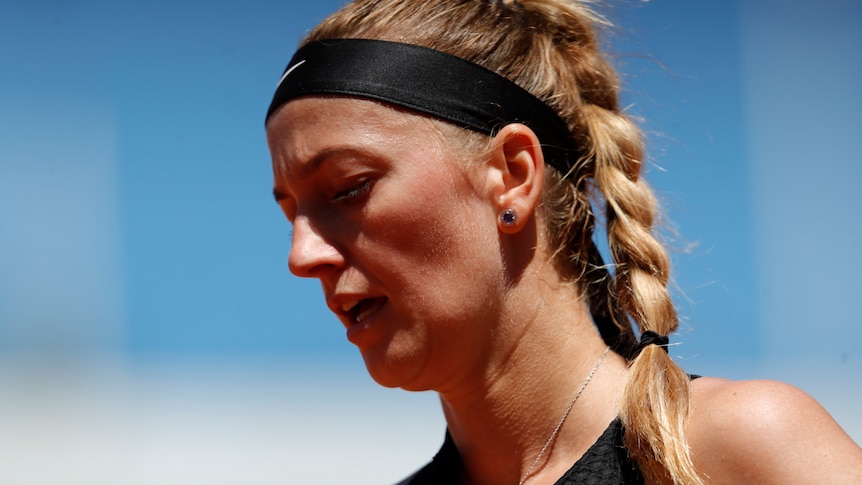 A close up of Petra Kvitova's face. She has her hair braided and is wearing a headband