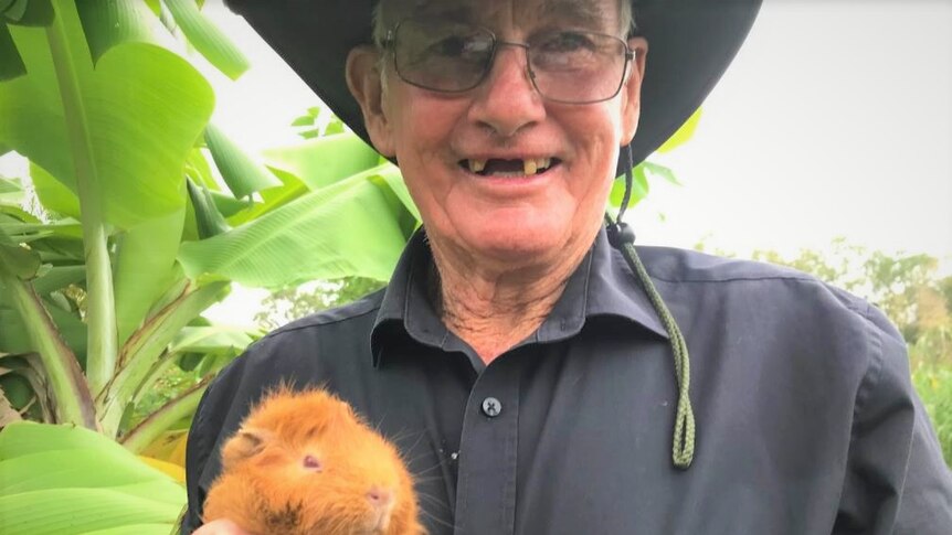 A man holding a guinea pig