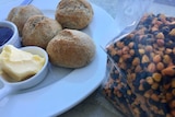 Bread rolls next to a bag of wattle seeds