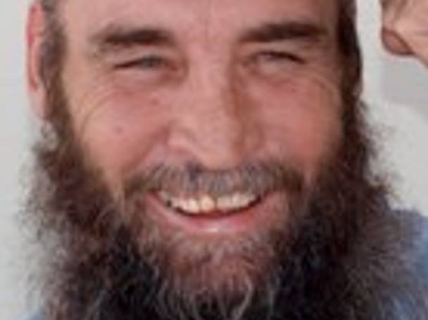 man with bushy beard smiling