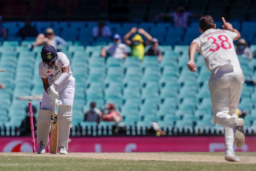 Cheteshwar Pujara's stumps are broken while he is mid-shot, as Josh Hazlewood begins to celebrate