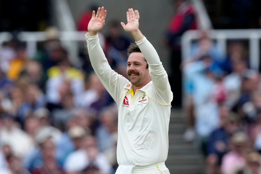 Australia bowler Travis Head raises both arms and smiles during an Ashes Test at Lord's.