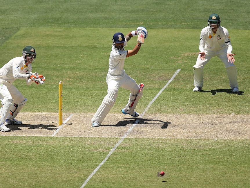 Virat Kohli of India bats in front of Brad Haddin and Steven Smith of Australia during day three of the First Test match between Australia and India at Adelaide Oval