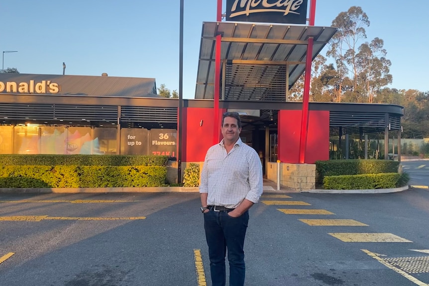 A man stands in a McDonald's car park