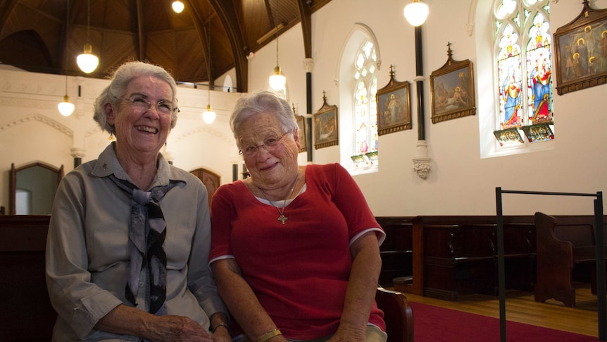 Two Good Shepherd nuns sitting on a pew at the Abbotsford Convent chapel.