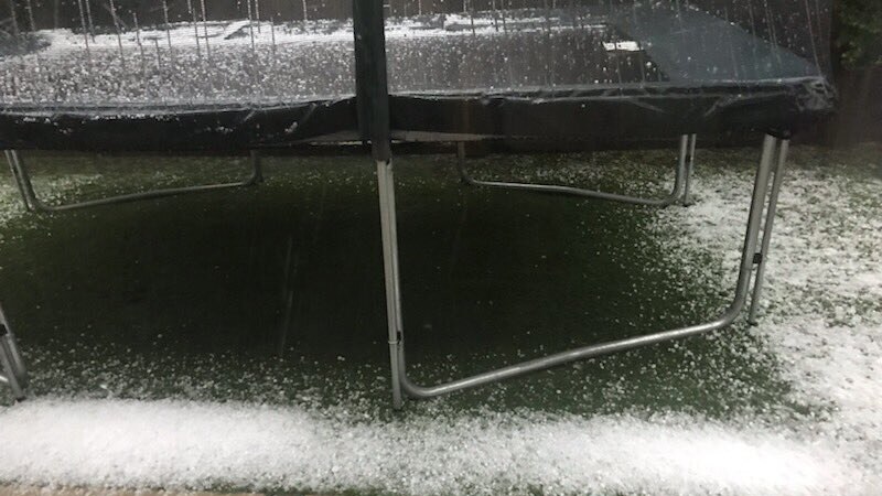 Hail on the ground and on a trampoline at a house on Brisbane's northside after storms.