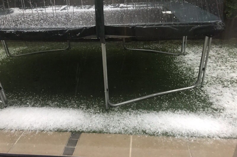 Hail on the ground and on a trampoline at a house on Brisbane's northside after storms.