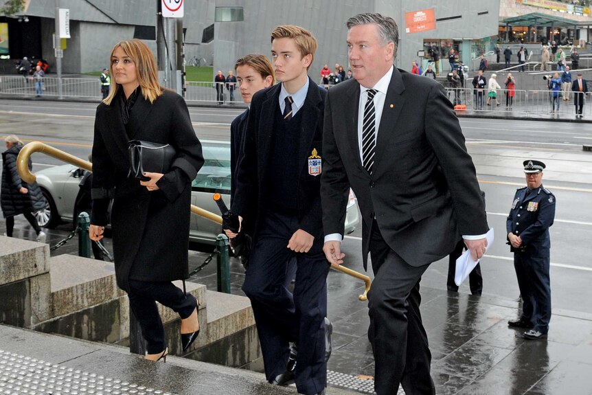 Eddie McGuire and his family walk up the steps of St Paul's Cathedral.