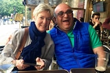 Kim Dahler sitting at a cafe with her husband smiling.