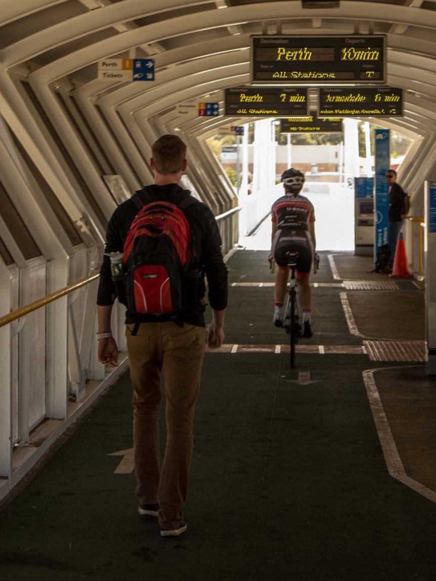 Cyclist and pedestrian at a Perth train station (Claisebrook).