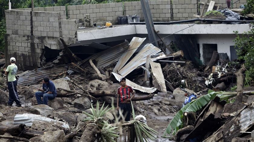 Deadly mudslide: Villagers stand amid debris in the town of Amatitlan