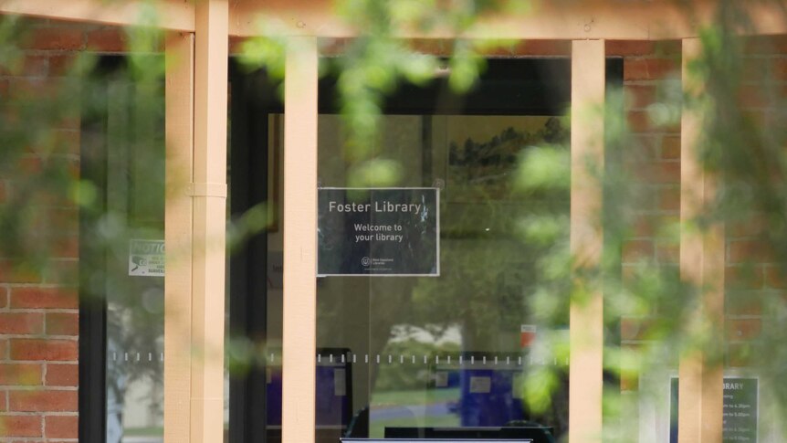 The doors into the Foster library. There's a sign saying "welcome to your library."