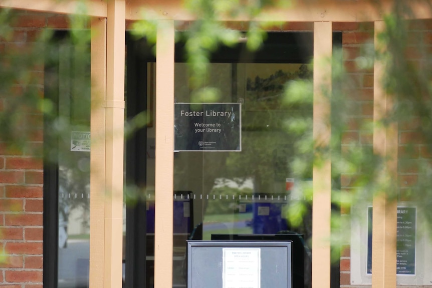 The doors into the Foster library. There's a sign saying "welcome to your library."