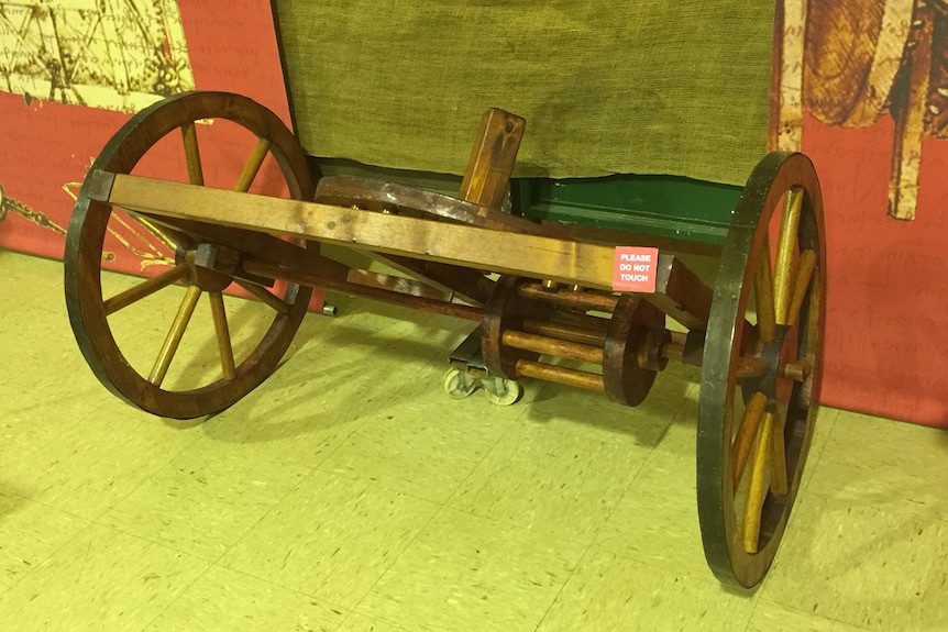 A small wooden cart with two wheels and a differential.