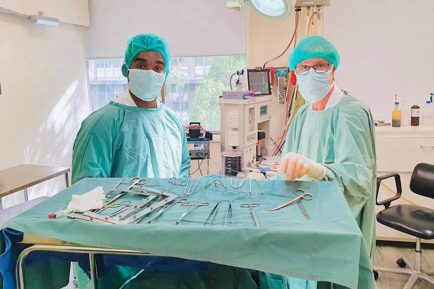 Researchers Dr Yugeesh Lankadeva and Professor Clive May stand in an operating theatre.