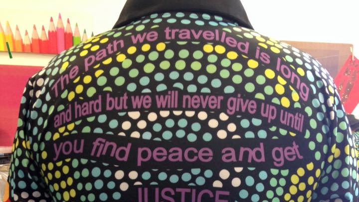 A jacket with Indigenous dot artwork and a verse pledging to tirelessly search for justice.