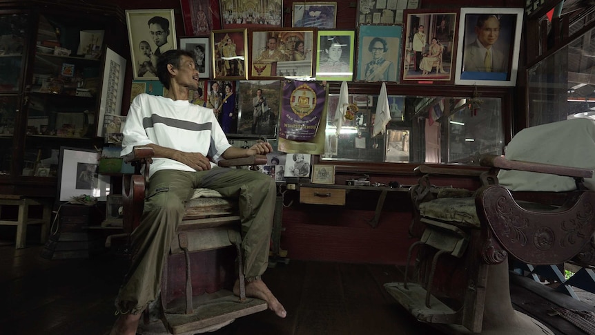 Thai barber shop lined with portraits of the royal family.