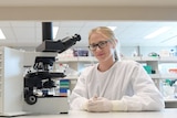 PhD student Ashleigh Osborne with a microscope in her laboratory.