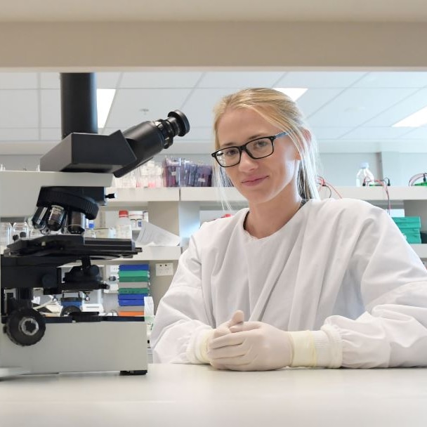 PhD student Ashleigh Osborne with a microscope in her laboratory.
