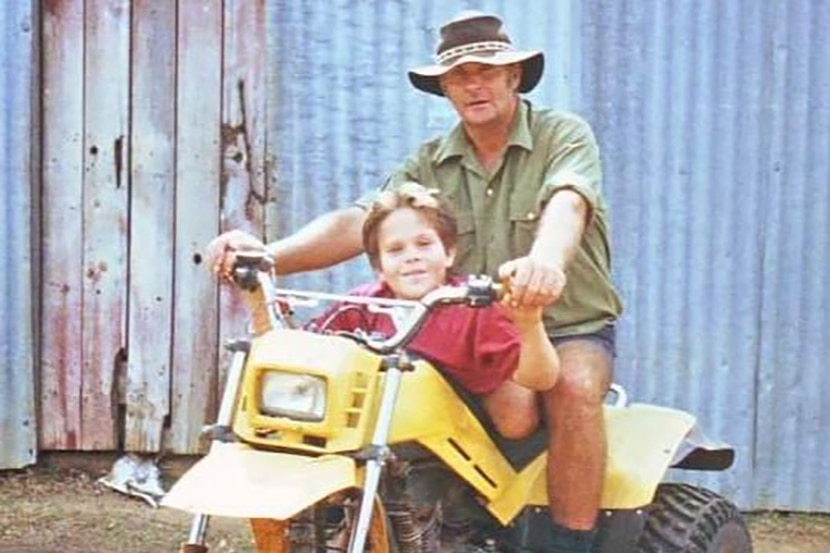 Terence John Oberle, with his young son Simon, on a tri-motorbike, in the early 2000s.