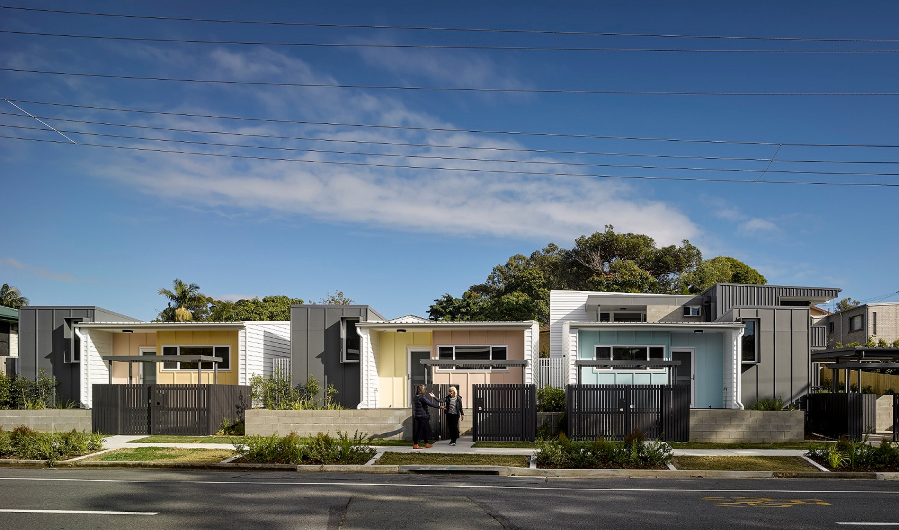 A collection of colourful social housing homes in a suburban setting