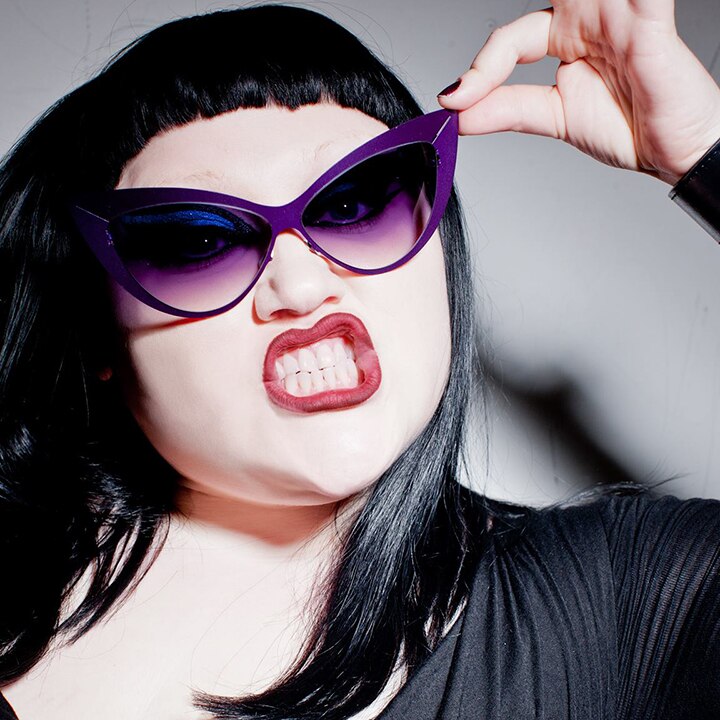 Beth Ditto wears sunglasses and shows her teeth